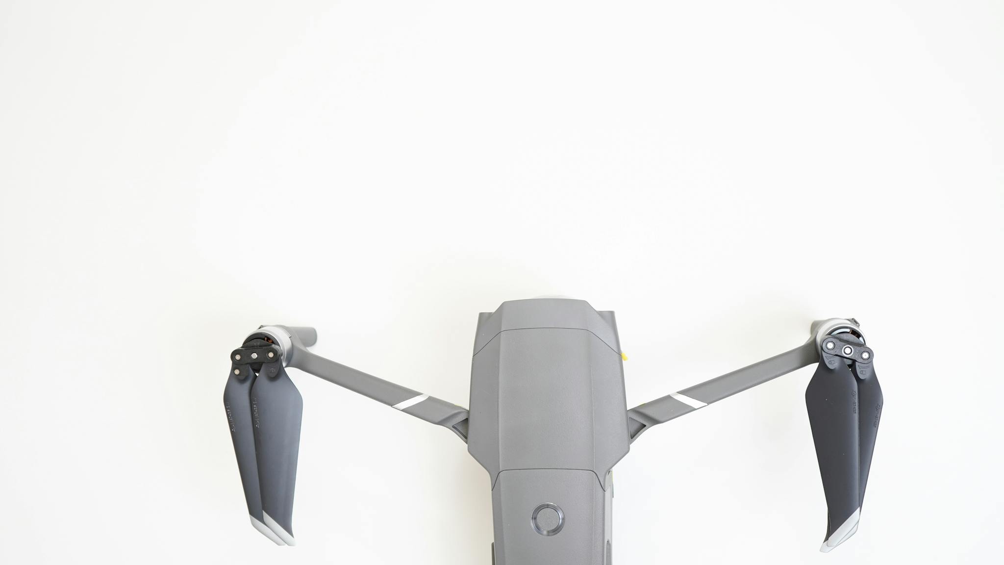 Top view of a high-tech drone on a minimal white background, showcasing modern technology.